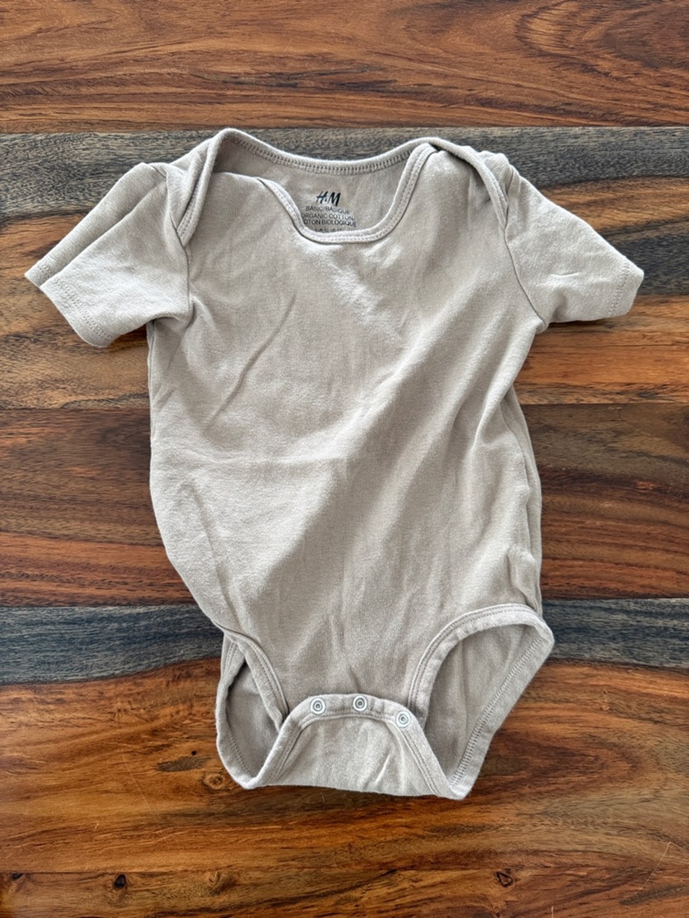 3/$10 - H&M Short-Sleeve Baby One-Piece in Light Taupe
